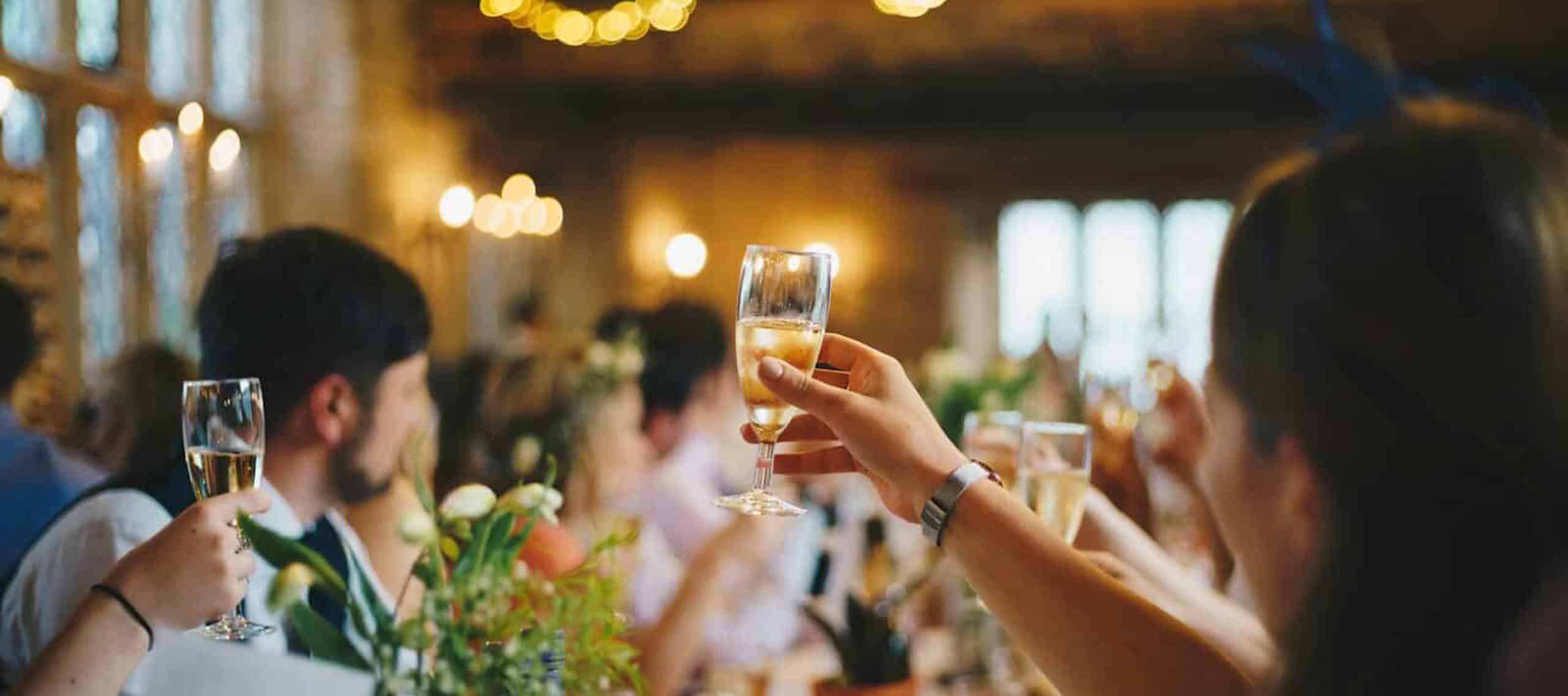 People raising glasses in toast at Garner Local event, celebrating community and local gatherings.